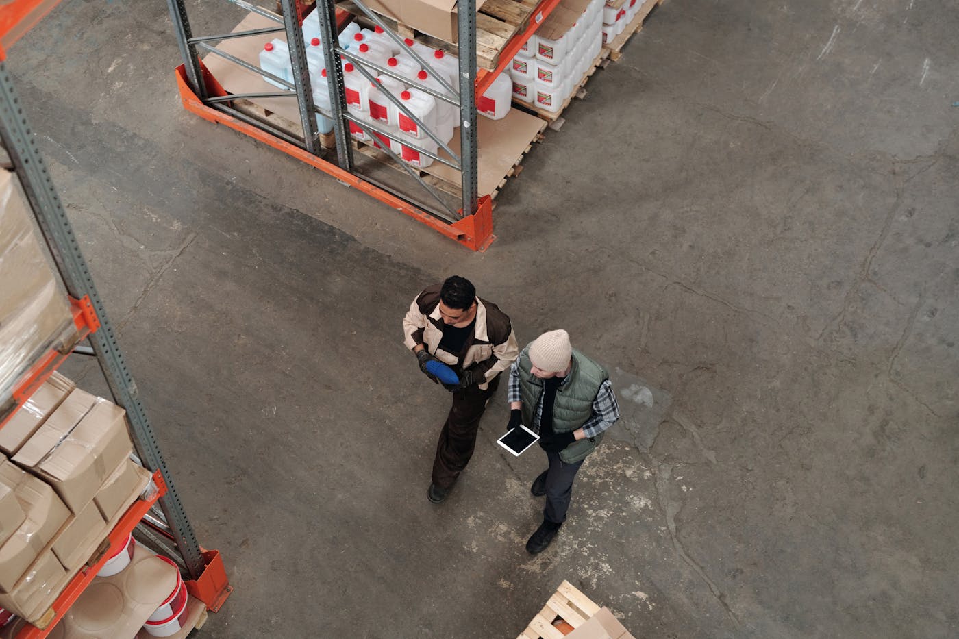 Warehouse team using a tablet to review inventory and wholesale orders.